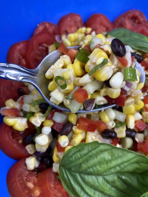 Corn Salad 3 Ways Harriett s Cooking corn-salad-on-a-plate-with-the-words-how-to-make-cajun-corn-salad-above-it